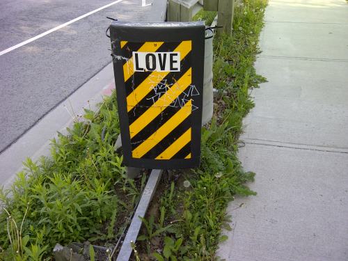 Traffic sign has the word LOVE added to it